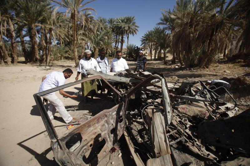 People and human rights activists examine the site of a U.S. drone strike that targeted suspected al Qaeda militants in August 2012, in the southeastern Yemeni province of Hadhramout, February 2013.