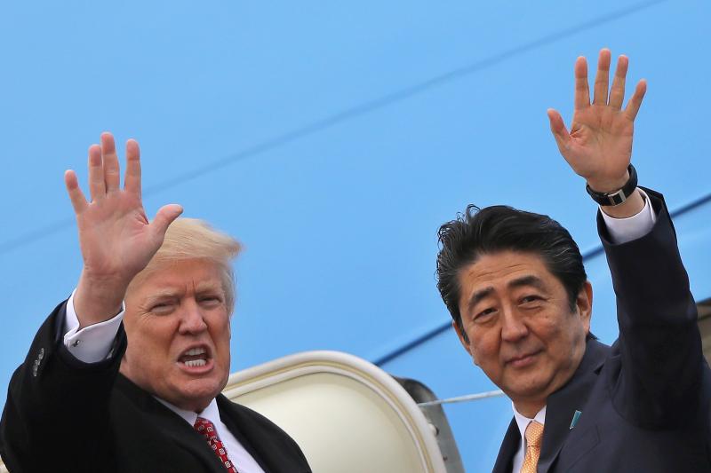 U.S. President Donald Trump and Japanese Prime Minister Shinzo Abe board Air Force One in Maryland, United States, February 2017.