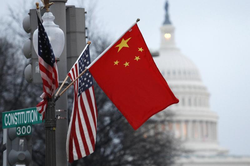 Chinese and U.S. flags fly on a lampost in Washington D.C., during Chinese President Hu Jintao&#039;s visit, January 2011