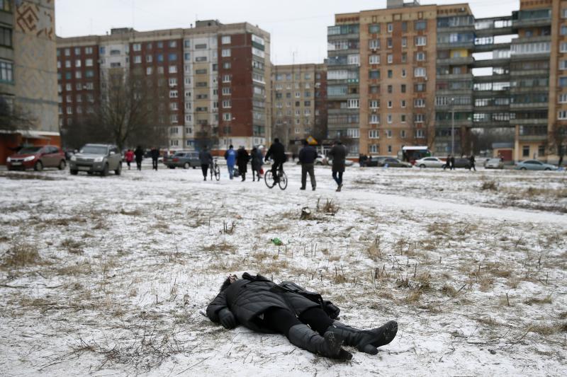 The body of a woman killed by recent shelling lies in a street in Kramatorsk, in eastern Ukraine, February 2015.